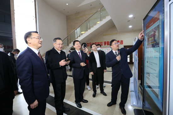 參加揭牌儀式的領導嘉賓查看下載“來賓融媒”APP。