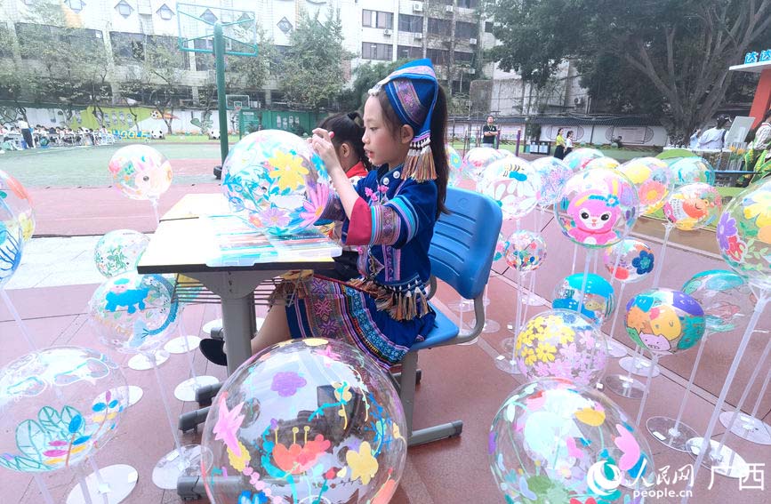 學(xué)生在波波球上畫畫。人民網(wǎng)記者 陳燕攝