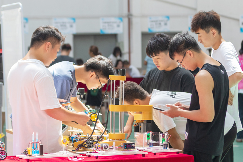 新生正在參觀3D打印機器操作。學(xué)校供圖