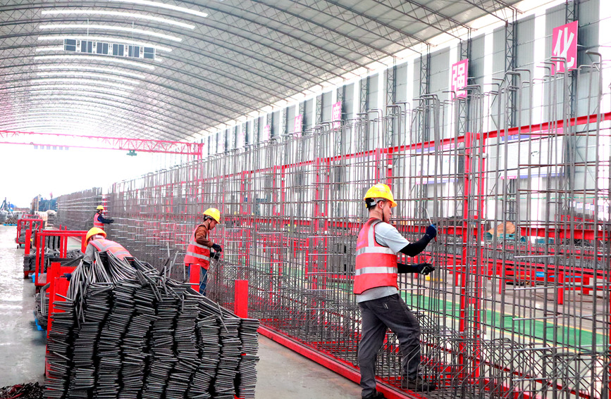 工人在進(jìn)行T梁底腹板鋼筋綁扎。謝雨婕攝