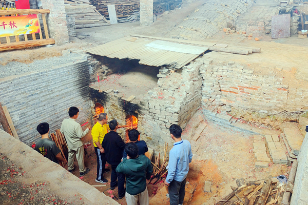 在藤縣濛江鎮(zhèn)陶春園，游客嘉賓參與燒窯添柴活動。