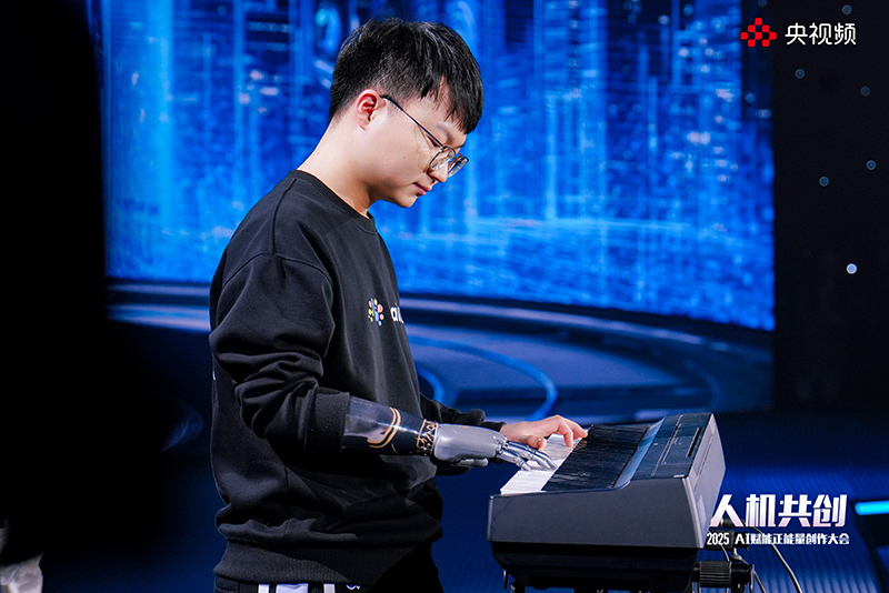 周鍵借助仿生手彈奏《大魚》。人民視頻供圖