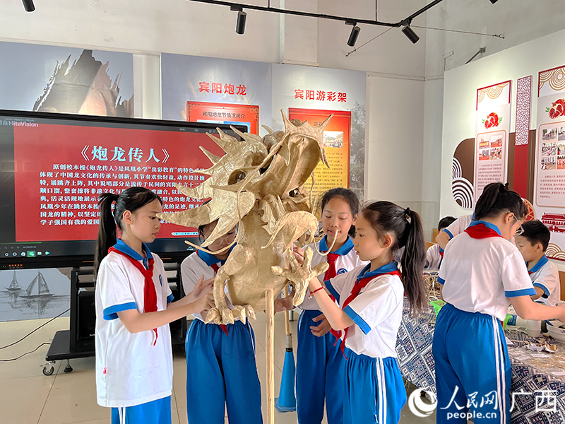 學(xué)生們?cè)趯W(xué)習(xí)制作炮龍。人民網(wǎng) 韋歡攝