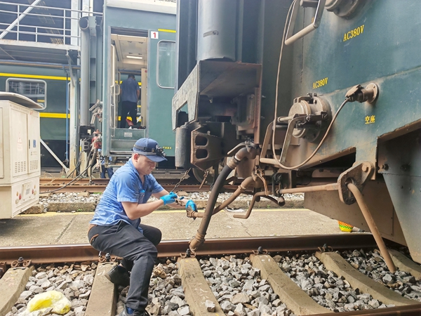 南寧車輛段客車檢車員正在對即將恢復(fù)開行的國際聯(lián)運列車進行技術(shù)狀態(tài)檢查。黃宏展攝
