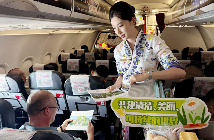 乘務(wù)員向旅客派發(fā)生態(tài)環(huán)境宣傳冊