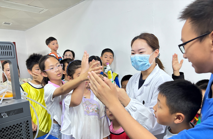 孩子們對實驗室里精密的設備與儀器充滿好奇，紛紛舉手提問。