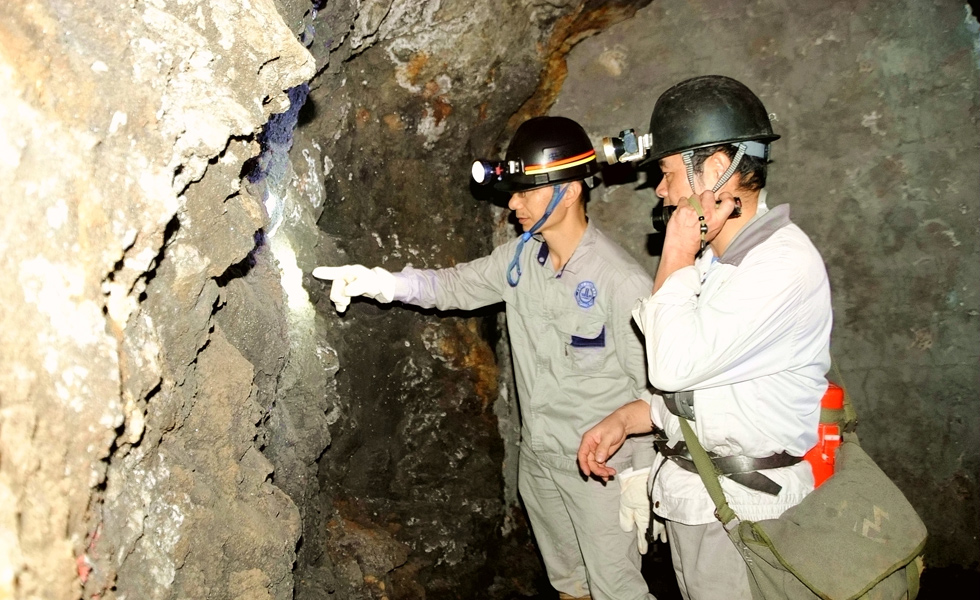 地質(zhì)工作者在查看窿道內(nèi)礦產(chǎn)露頭情況